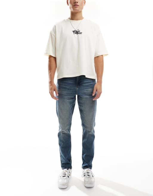 ASOS DESIGN – Slim Fit Stretch-Jeans in mittelblauer Vintage-Waschung