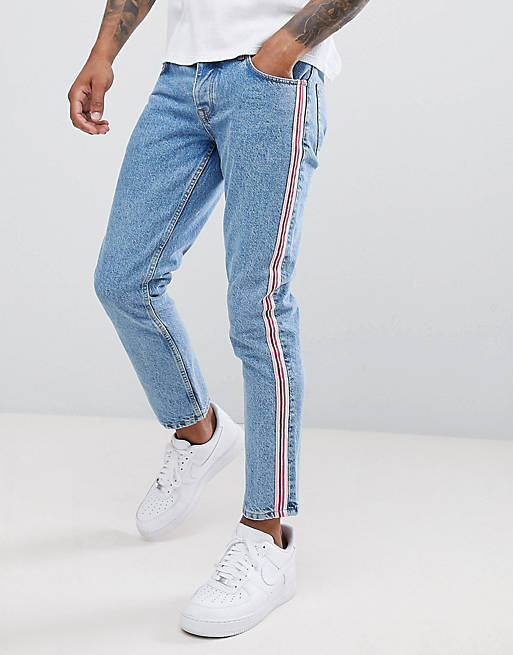 ASOS DESIGN slim jeans in mid wash blue with pink side stripe