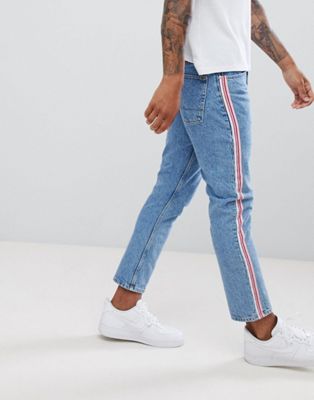ASOS DESIGN slim jeans in mid wash blue with pink side stripe
