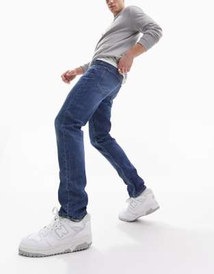 ASOS DESIGN slim jeans in mid wash blue - ASOS Price Checker
