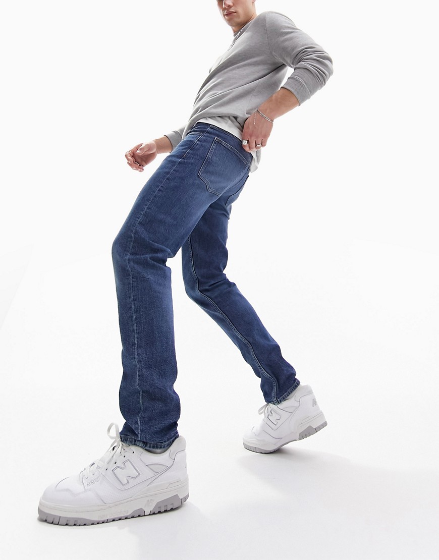 ASOS DESIGN slim jeans in midwash blue