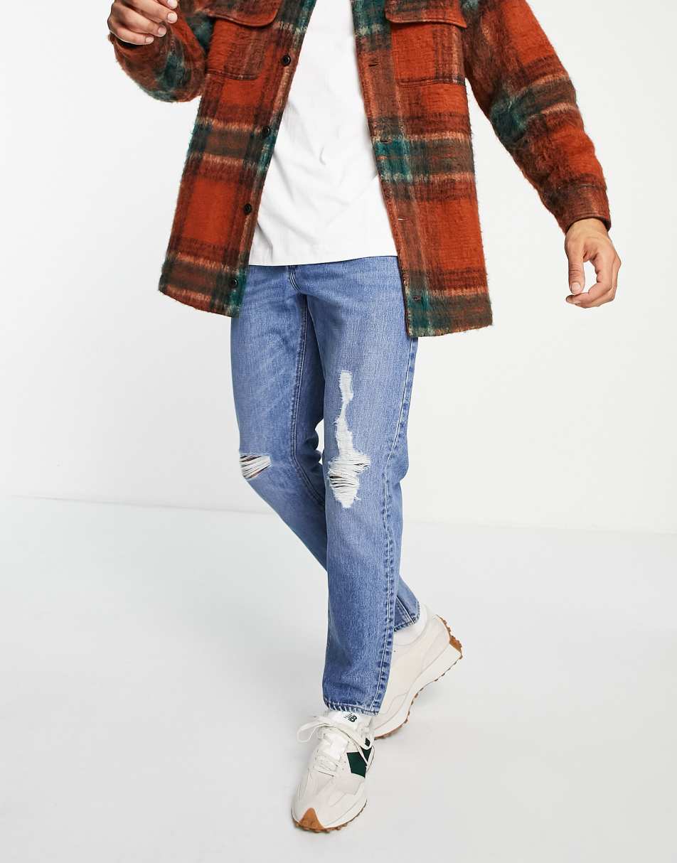 ASOS DESIGN slim jeans in vintage mid wash with knee rips