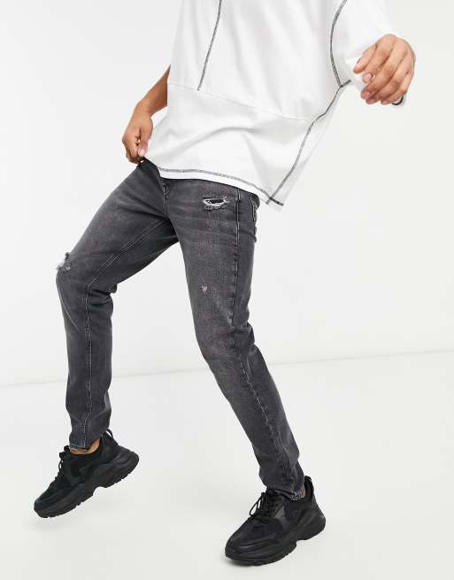 ASOS DESIGN slim jeans in washed black with distressing