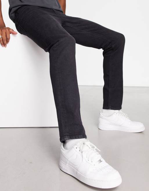 ASOS DESIGN super skinny jeans in washed black with paint splatter