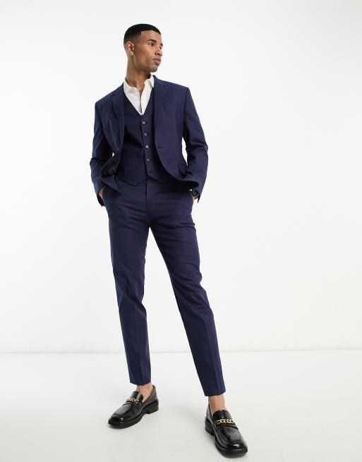 Man in blue dress shirt and black dress pants standing photo