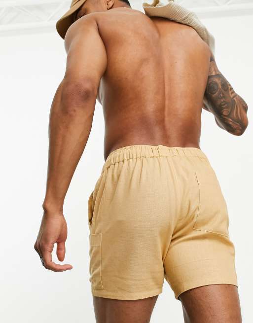 ASOS DESIGN swim shorts in short length in beige