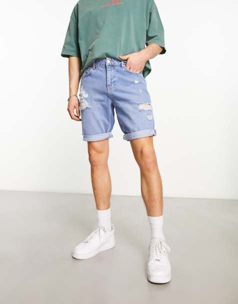 ASOS DESIGN stretch mid length denim shorts in flat mid wash blue