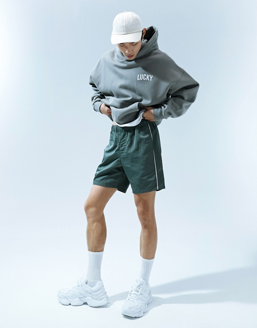 ASOS DESIGN slim nylon shorts with piping detail in khaki-Green