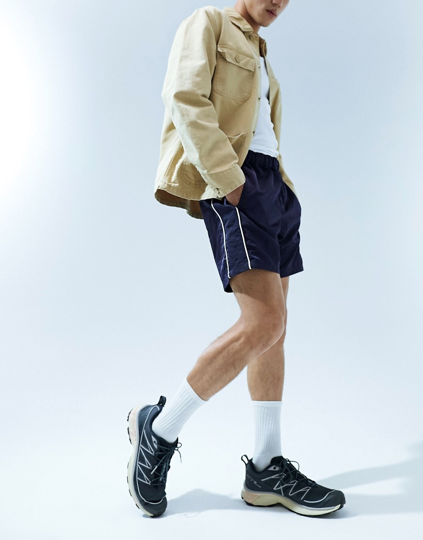 ASOS DESIGN slim nylon shorts with piping detail in navy