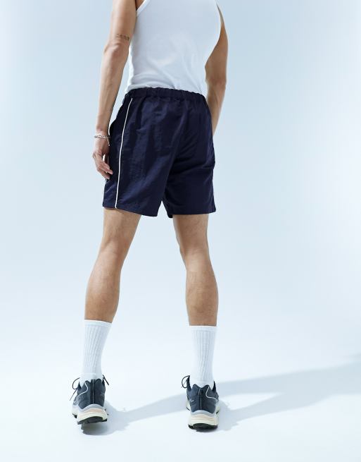 ASOS DESIGN slim nylon shorts with piping detail in navy