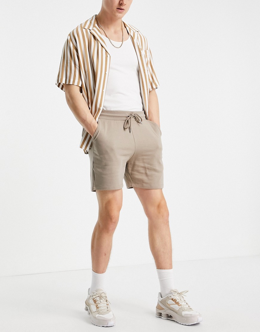 ASOS DESIGN slim shorter length jersey shorts in beige-Neutral