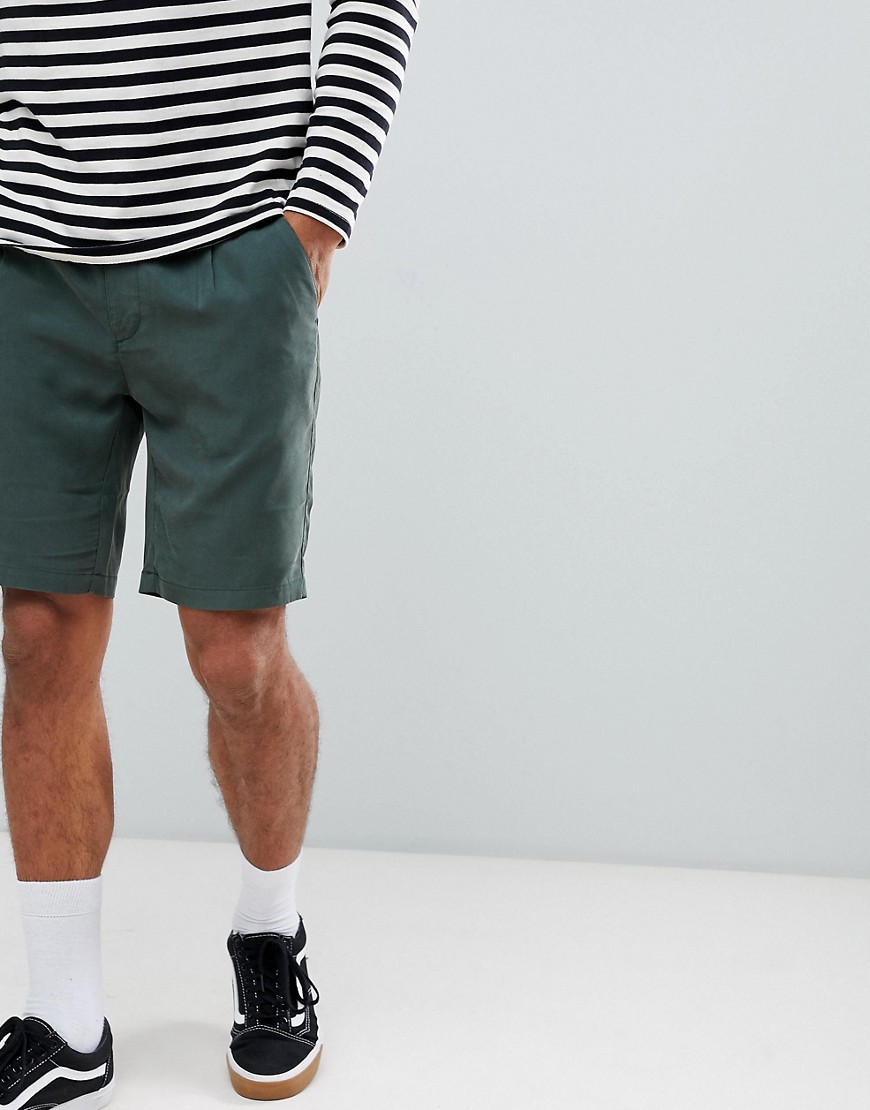 ASOS DESIGN slim shorts in dark green in drapey fabric