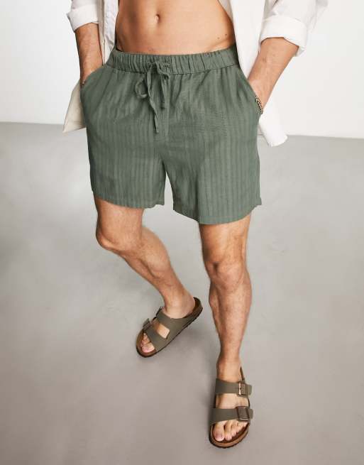 ASOS DESIGN slim textured shorts in shorter length in dark green