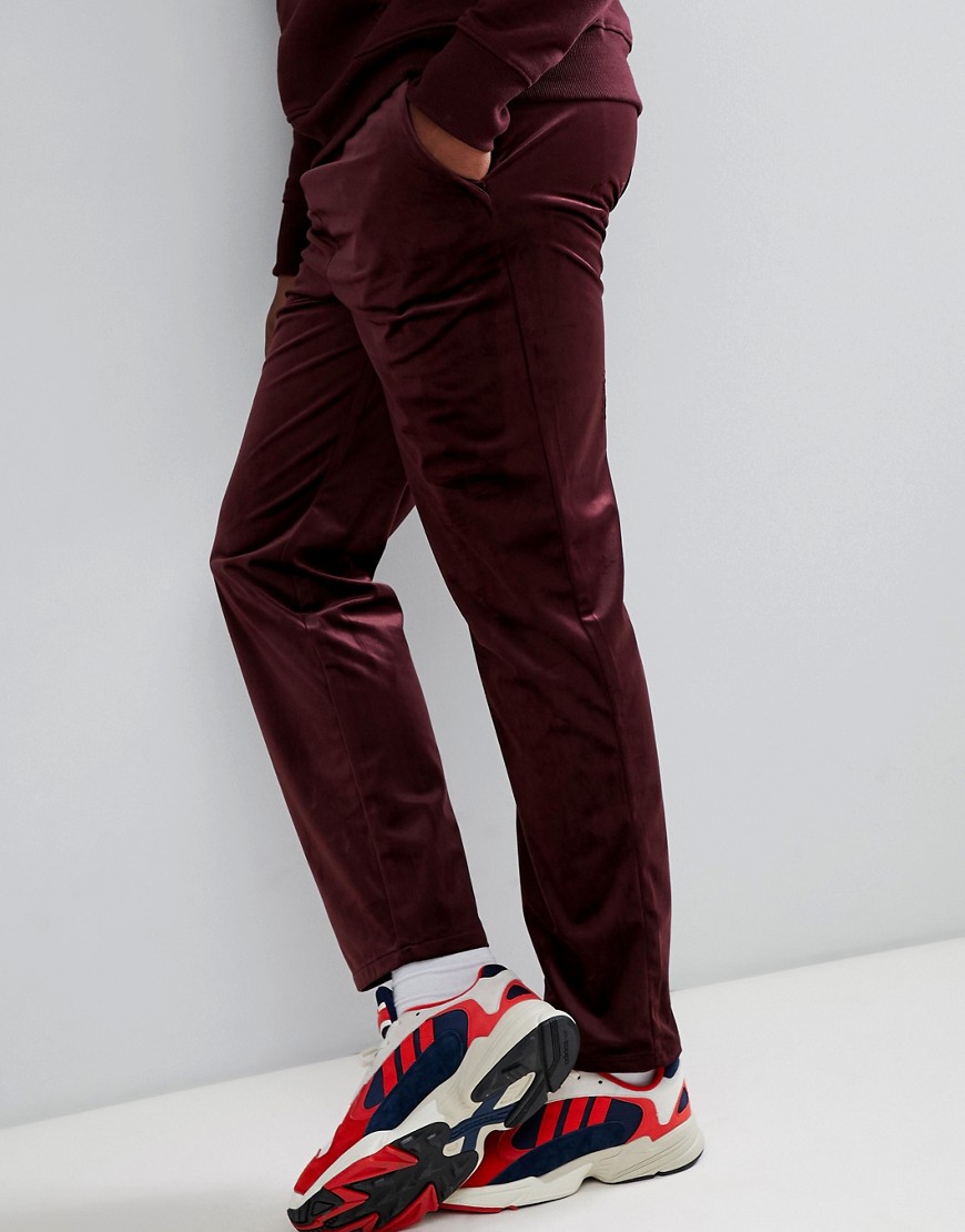 ASOS DESIGN slouch fit trousers in burgundy velour-Red