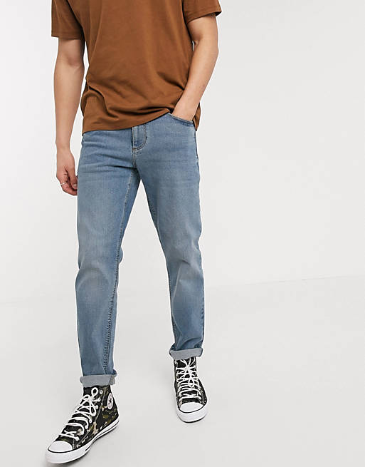 ASOS DESIGN - Smaltoelopende stretch jeans in blauwe midwash