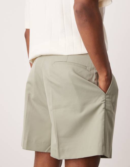 ASOS DESIGN smart bermuda shorts with front pleat and belt detail in green 