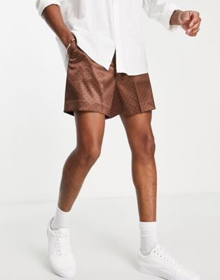 ASOS DESIGN smart cropped bermuda satin shorts with retro monogram print in brown