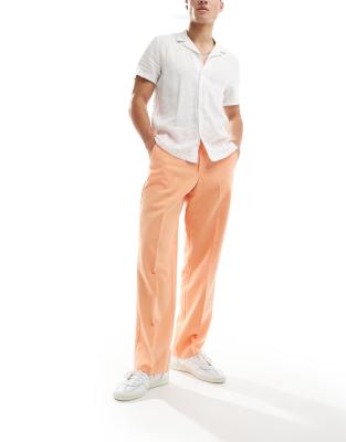 Pantalones naranjas acampanados de pernera ancha y corte holgado de ASOS  DESIGN