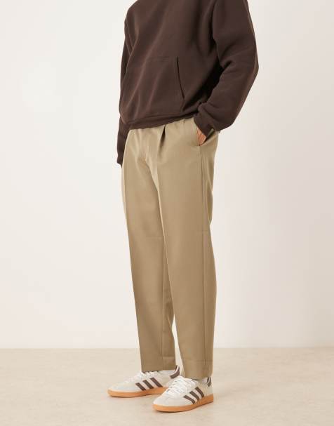 ASOS DESIGN – Smarte, schmal zulaufende Oversize-Hose in Khaki mit Bügelfalten und sichtbarem Knopf - view 1