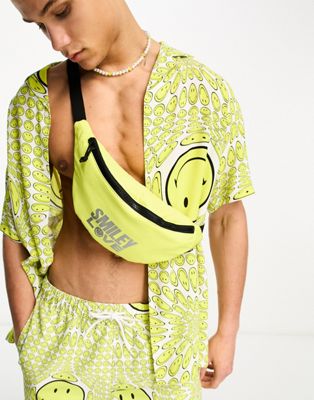 ASOS Design Smiley Collab bumbag with foil love slogan in yellow