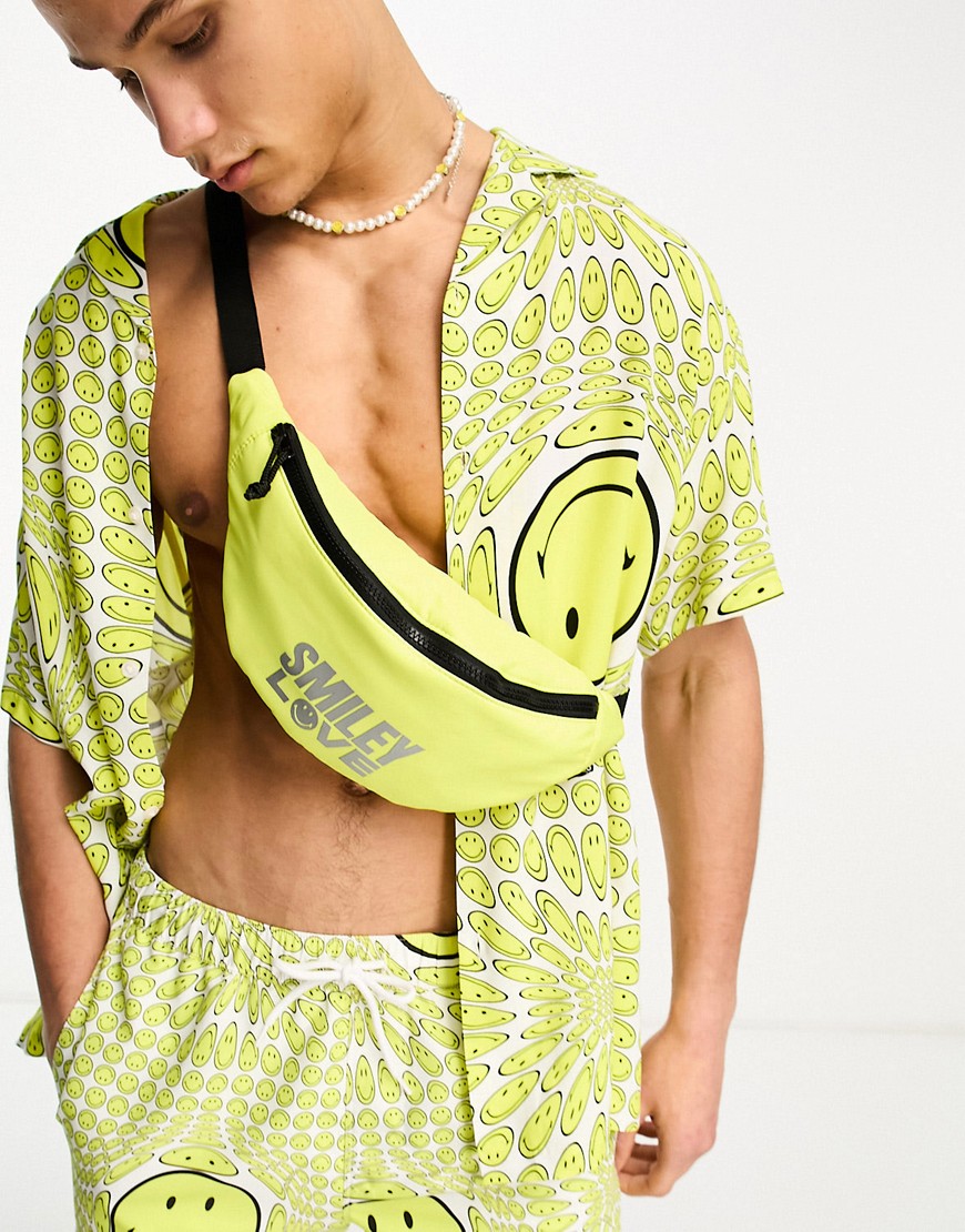 Asos Design Smiley Collab Fanny Pack With Foil Love Slogan In Yellow