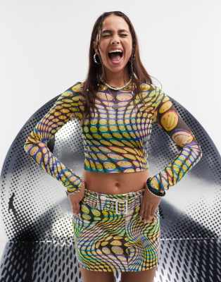 ASOS DESIGN SMILEY COLLAB LONG SLEEVE MESH TOP LICENSE GRAPHIC IN ALL OVER PRINT-MULTI 