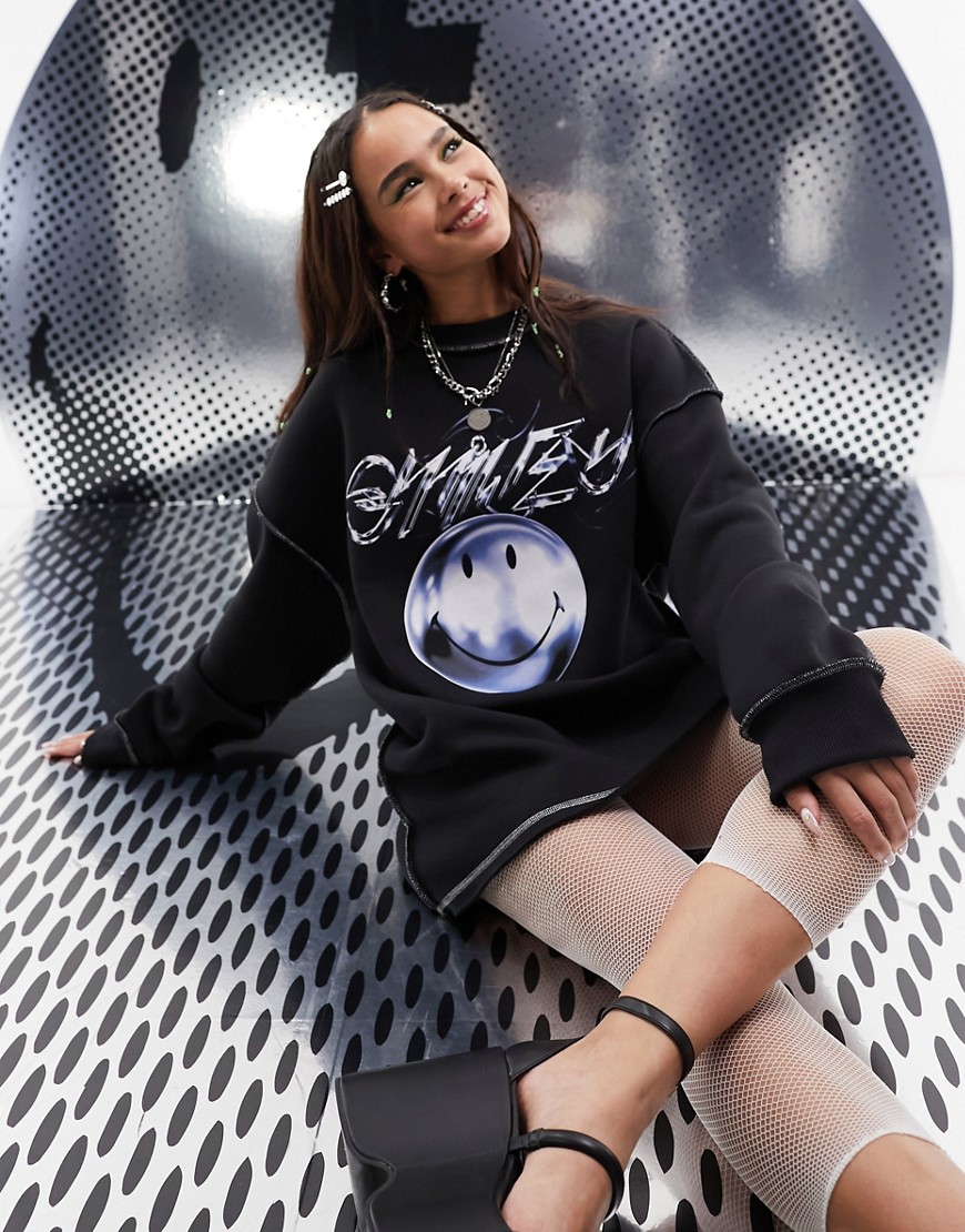 ASOS DESIGN Smiley Collab oversized sweat license graphic with metallic seam detail in black