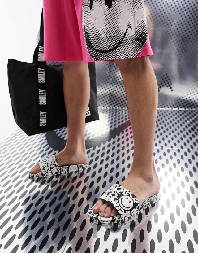 ASOS DESIGN smiley collab slides in black and white print