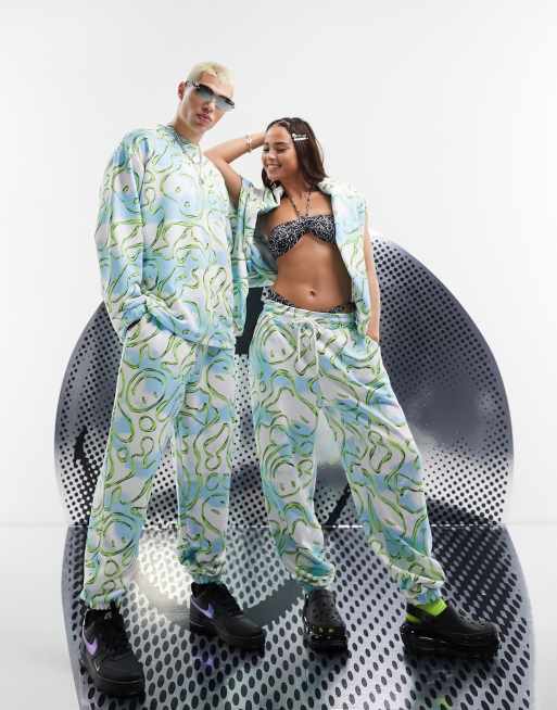 ASOS DESIGN - Smiley Collab - Uniseks joggingbroek met Smiley-prints in blauw met wit