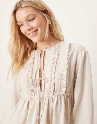 smock top with ruffle detail and tie neck in natural-White