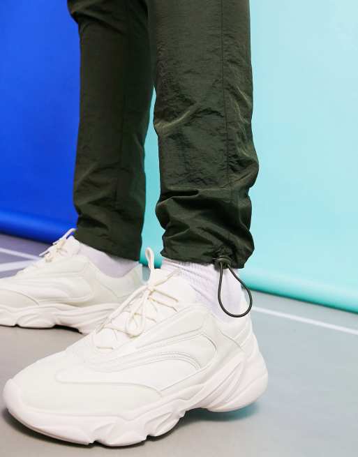 ASOS DESIGN sneakers in white with translucent blue sole