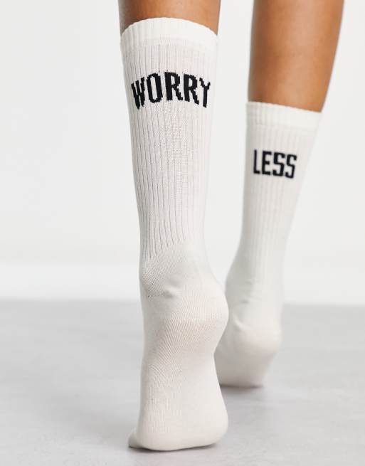 ASOS DESIGN  socks with worry less slogan in off white
