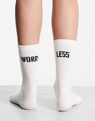 ASOS DESIGN  socks with worry less slogan in off white