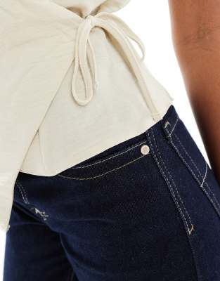 asos design soft touch wrap sleeveless blouse in buttermilk
