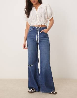 soft wide leg jeans with rips in bright mid blue