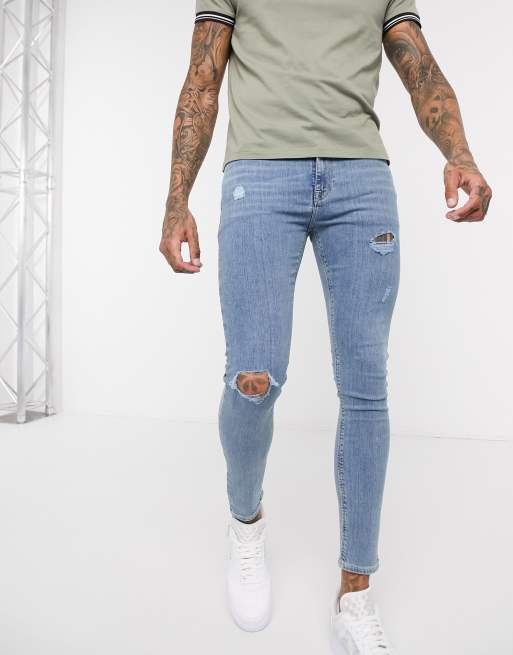 ASOS DESIGN spray-on distressed jeans in power stretch denim in light blue  wash