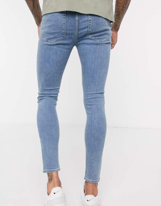 ASOS DESIGN spray on jeans in power stretch denim in light wash