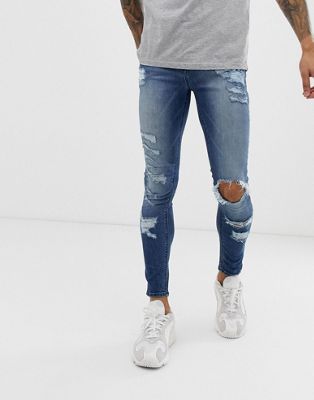 ASOS DESIGN – Spray-on-Jeans aus Power-Stretch mit starken Rissen in verwaschenem Mittelblau
