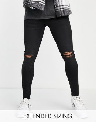 ASOS DESIGN spray on jeans in power stretch in black with busted knee