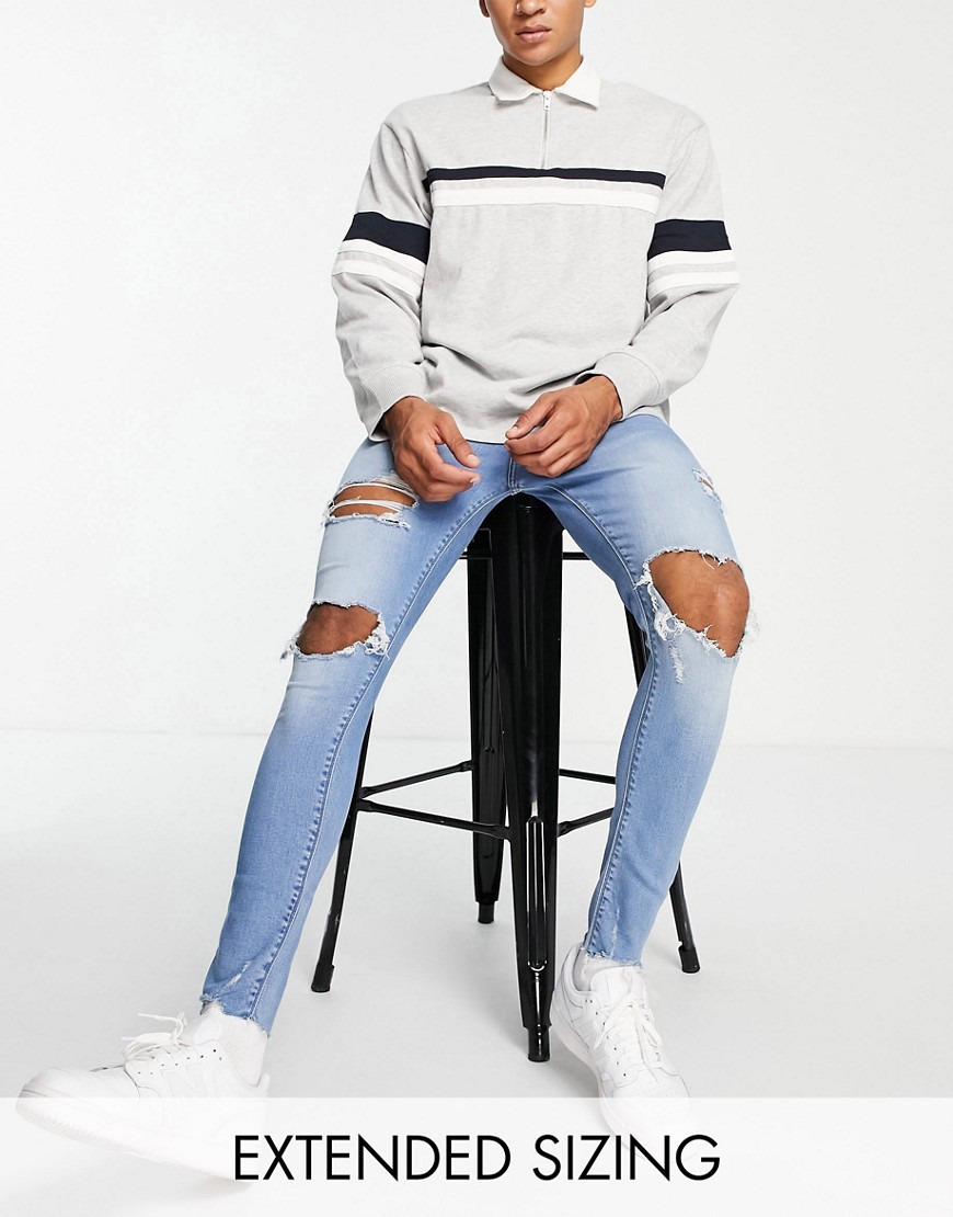 ASOS DESIGN spray on jeans in power stretch in mid wash with heavy rips-Blue