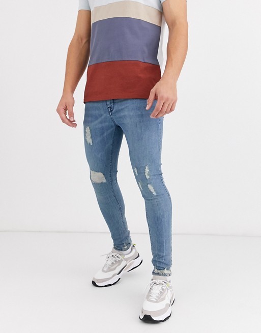 ASOS DESIGN spray on jeans in power stretch in vintage light wash with rips