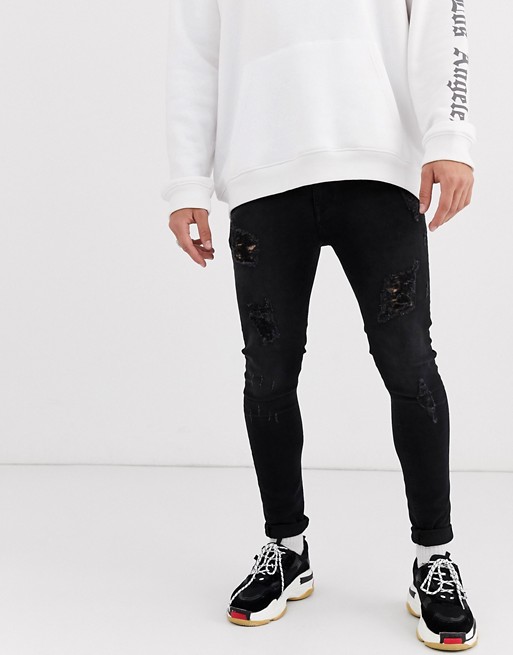 ASOS DESIGN spray on jeans in power stretch in washed black with heavy rips
