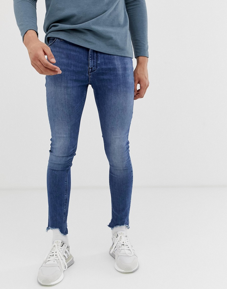 ASOS DESIGN spray on jeans in power stretch with raw hem in blue