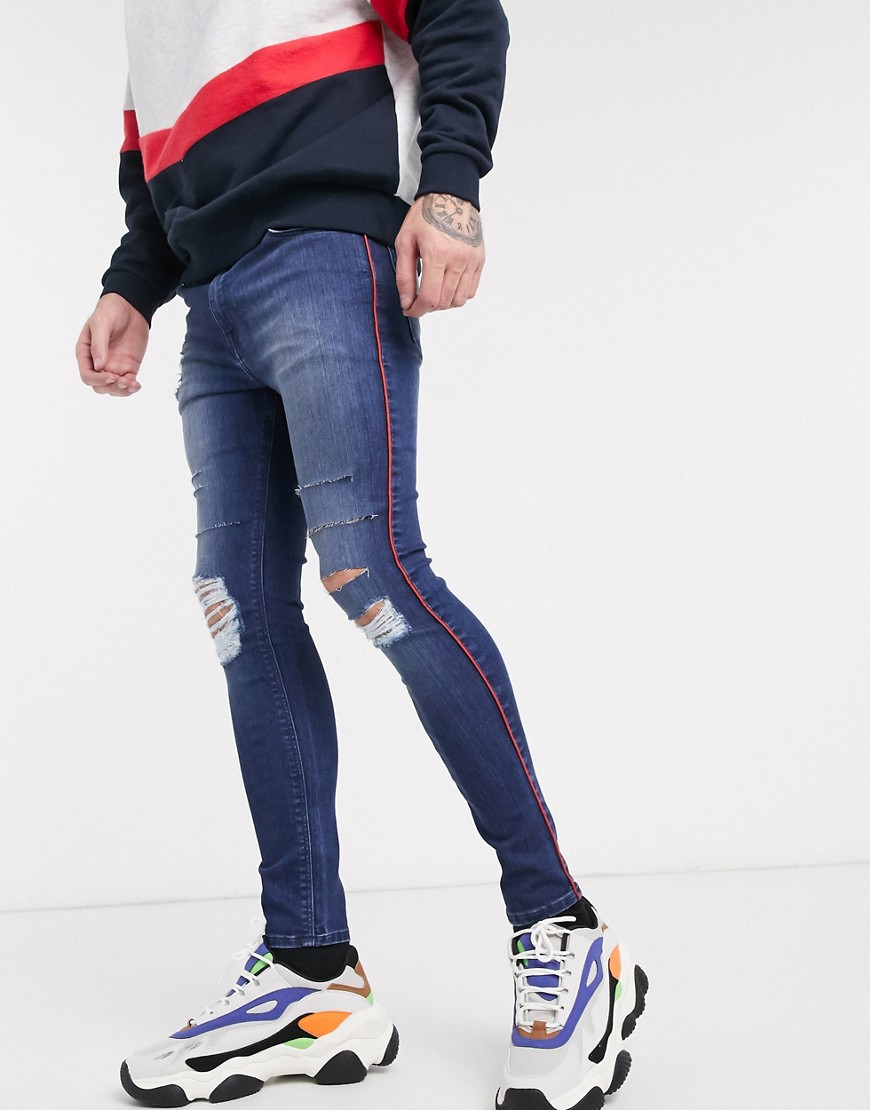 ASOS DESIGN spray on jeans in power stretch with side stripe and heavy rips-Blue