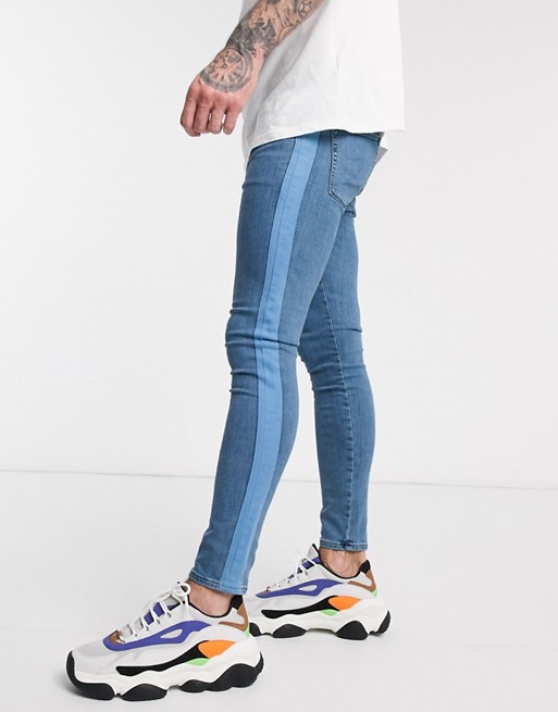 ASOS DESIGN spray on jeans in power stretch with side stripe in mid wash blue