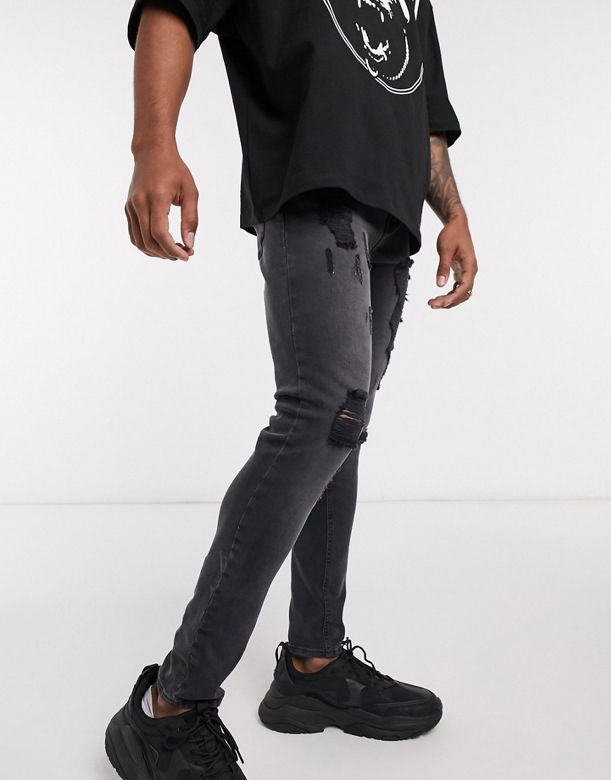ASOS DESIGN spray on jeans in washed black with heavy rips