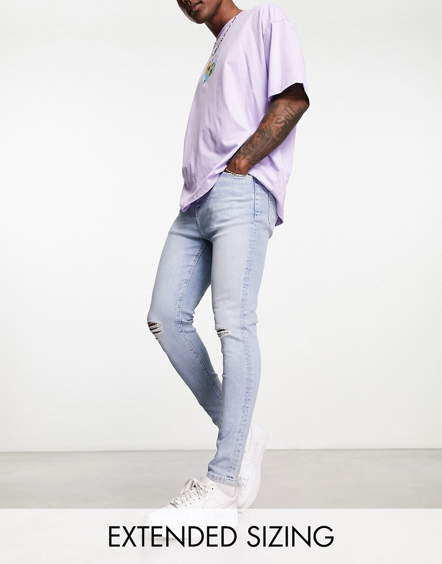 ASOS DESIGN spray on jeans with power stretch and knee rips in light wash blue