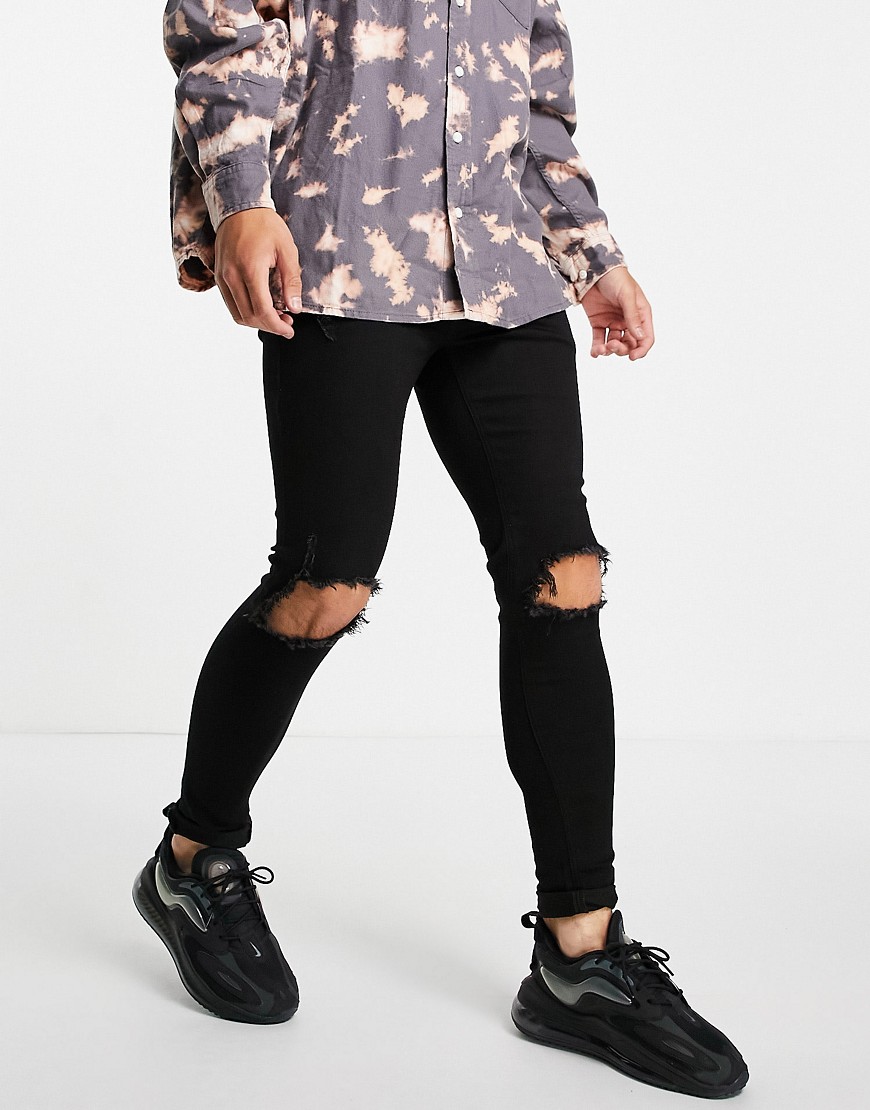 ASOS DESIGN spray on jeans with power stretch in black with knee rips
