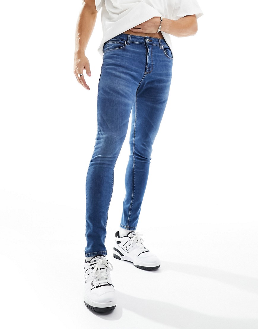 ASOS DESIGN spray on jeans with power stretch in dark vintage tint-Blue