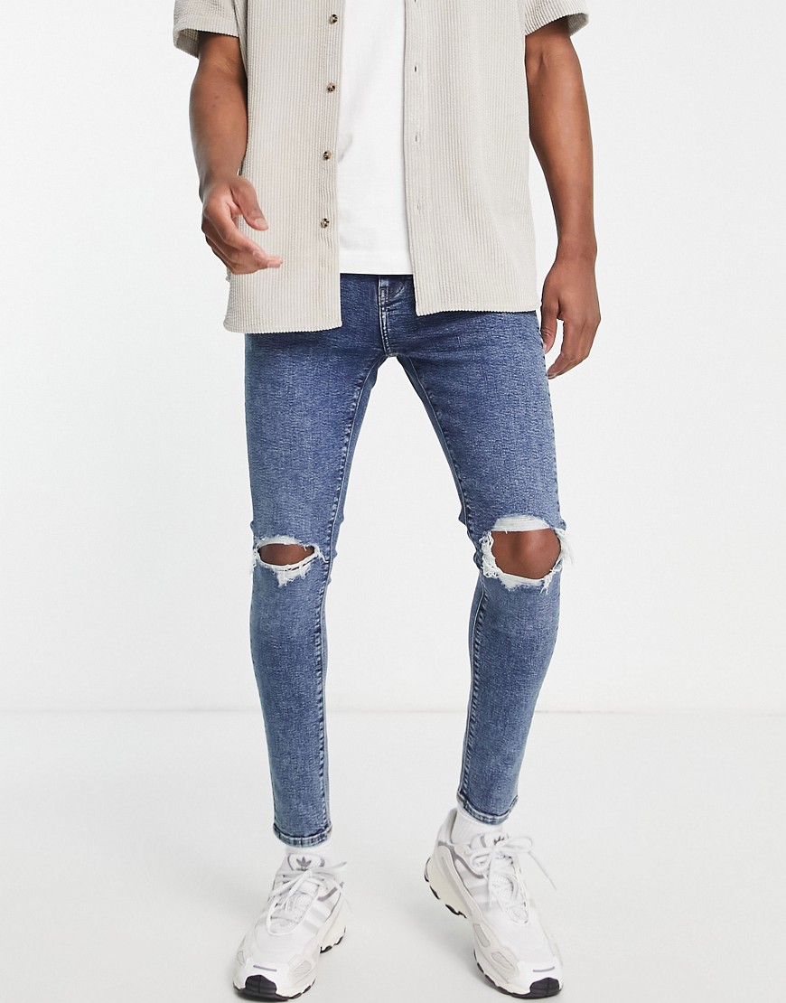 ASOS DESIGN spray on jeans with power stretch in dark wash blue with knee rips